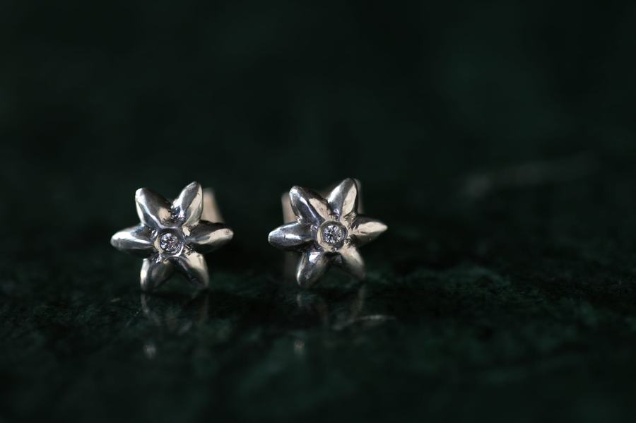 Star-shaped silver stud earrings with tiny gems
